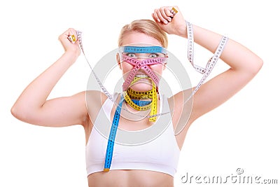 Obsessed fitness woman with a lot of colorful measure tapes Stock Photo