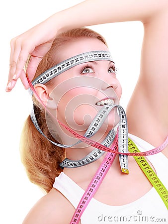 Obsessed fitness woman with a lot of colorful measure tapes Stock Photo