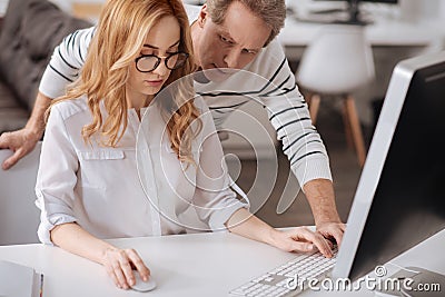 Obsessed mature boss distracting young secretary in the office Stock Photo
