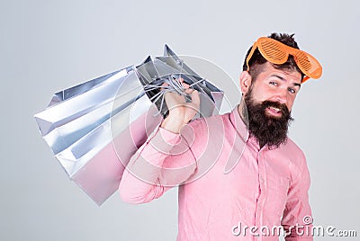 Obsessed with shopping. Addicted consumer concept. Man carefree bearded hold shopping bags. Shopping dumb wasting money Stock Photo