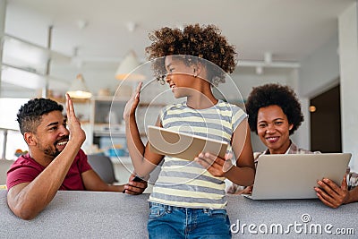 Obsessed to tech devices happy african american family using digital tablet, computer, smartphones Stock Photo