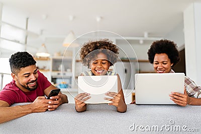 Obsessed to tech devices happy african american family using digital tablet, computer, smartphones Stock Photo