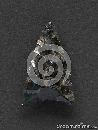 Obsidian arrowhead on white background Stock Photo