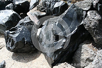 Obsidian boulders from lava flow Stock Photo