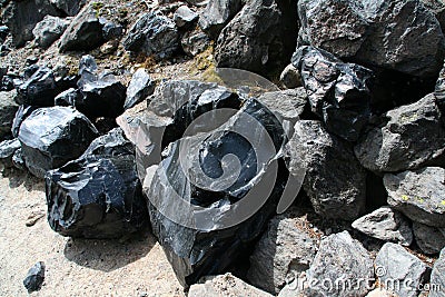 Obsidian boulders from lava flow Stock Photo