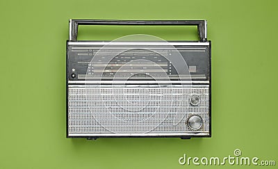 Obsolete retro radio receiver on a green pastel background. Stock Photo