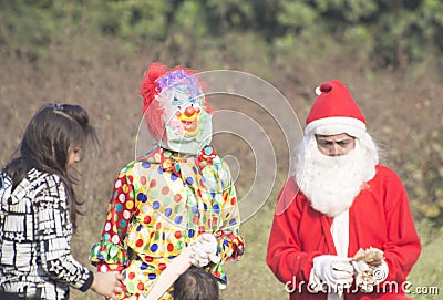 On the occassion of Christmas day little children have dressed up in Santa Clauses attire Editorial Stock Photo