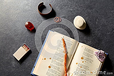 Magic book, wax candle, matches and gem stones Stock Photo