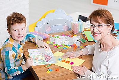 Occupational therapist and kid with adhd Stock Photo