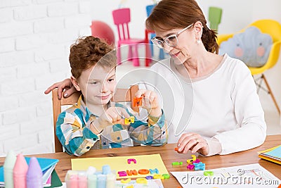 Occupational therapist and little boy Stock Photo