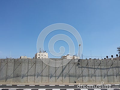 Occupied Palestinian suburb behind closed wall Stock Photo