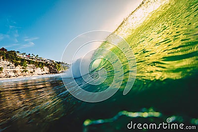 Ocean barrel wave at sunset with green colors. Perfect wave for surfing in Hawaii Stock Photo