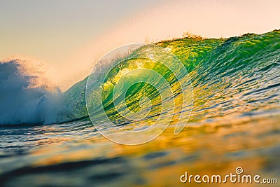 Ocean barrel wave at sunset. Perfect wave for surfing in Hawaii Stock Photo