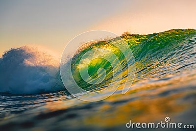 Ocean barrel wave at sunset. Perfect wave for surfing in Hawaii Stock Photo