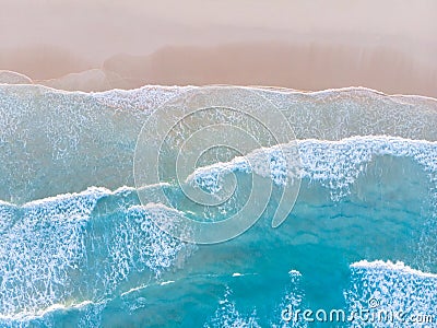 Ocean beach aerial top down view with blue water, waves with foam and spray and fine sand, beautiful summer vacation holidays Stock Photo