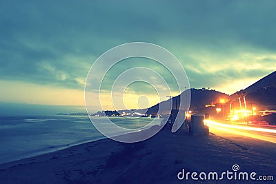 Ocean Beach and Car Head lights Stock Photo