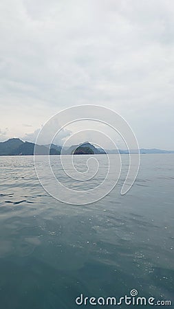 the ocean and an island that looks very calm Stock Photo