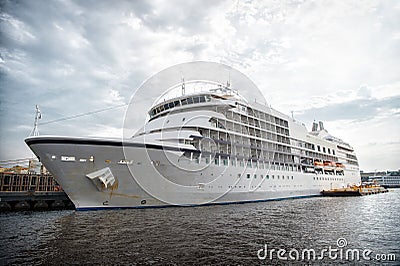 Ocean liner at sea pier in manaus, brazil. Passenger ship on cloudy sky. Sea transport and vessel. Summer vacation and holiday. Wa Stock Photo