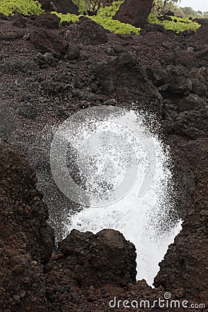 Ocean Spray on Black Rocks Stock Photo