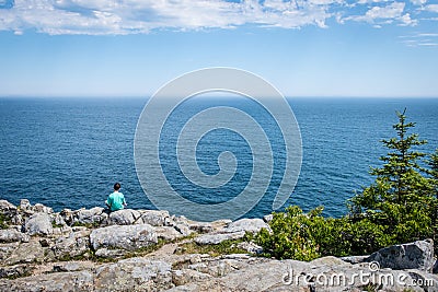 Taking in the Ocean View from a cliff in Acadia National Park Stock Photo
