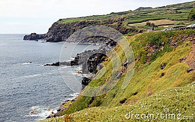Ocean view from the cliff, volcanic rocks below, Cinco Ribeiras, Terceira, Azores, Portugal Stock Photo