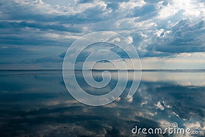 Ocean view and clouds reflection in the water in Gili Air Island Stock Photo