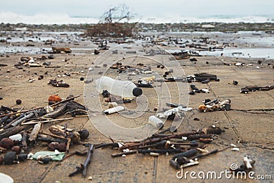 Ocean water pollution with plastic waste and water bottles, spilled garbage on city sea beach Stock Photo