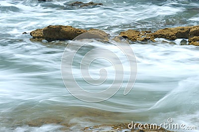 Ocean water rushing over reef Stock Photo