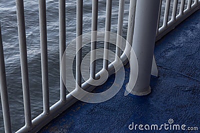 Ocean waters seen through ship railings, early morning light Stock Photo