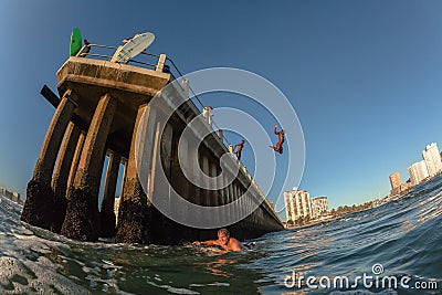 Ocean Waters Surfing Durban Pier Paddle Jump surfers swimmers Editorial Stock Photo