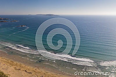 ocean waves, sandy beach with people bathing in the water, top view, Lanzada beach, Galicia, Spain Stock Photo