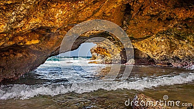 Ocean waves Under the Natural bridge formation in Aruba`s north coast Stock Photo