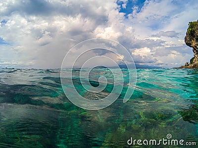 Oceanic landscape with transparent water and blue sky. Blue sea water look through. Stock Photo
