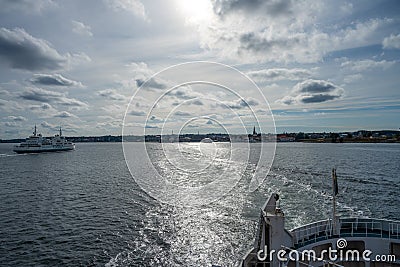 Ocean view towards Elsinore in Denmark from the aft of a boat. Backlit picture with blue ocean and blue sky Editorial Stock Photo