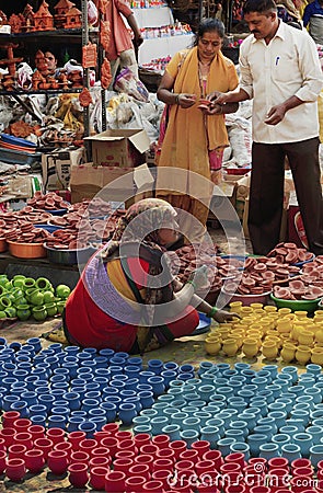 Unidentified vendor selling Diwali lamps and colorful pots at Kumbhar wada, Pune, India Editorial Stock Photo