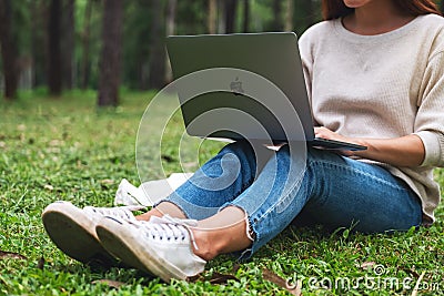 Oct 30th 2020 : A woman using Apple MacBook Pro laptop computer in the park , Chiang mai Thailand Editorial Stock Photo