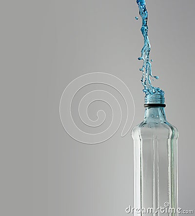 Octagon shaped glass bottle with water frozen with high speed flash photography Stock Photo