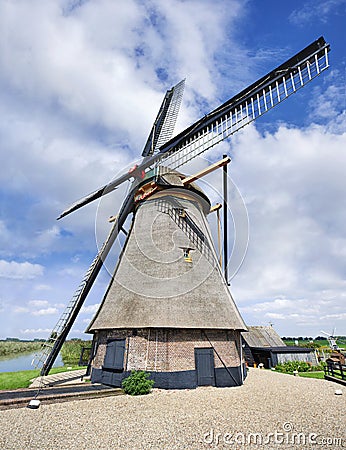 Octagonal drainage windmill with thatched roofing, blue sky and clouds, Netherlands. Stock Photo