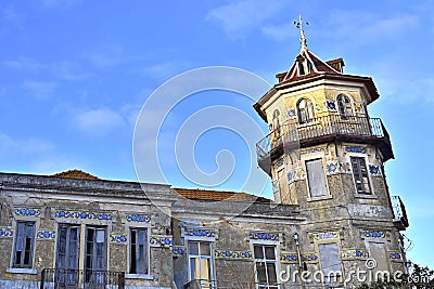 Octagonal tower with four floors, tiled friezes on facades, balconies and wrought iron railings. Stock Photo