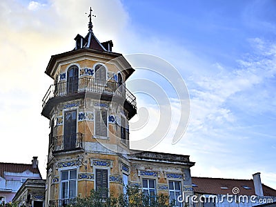 Octagonal tower with four floors, tiled friezes on facades, balconies and wrought iron railings. Stock Photo