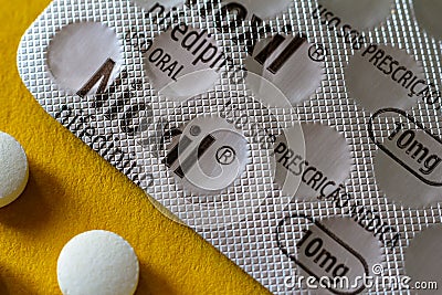 October 10, 2020, Brazil. In this photo illustration a pack of Nioxil Nifedipino with some pills. Medication is indicated for Cartoon Illustration