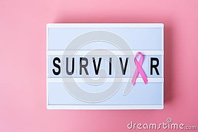 October Breast Cancer Awareness month, Pink Ribbon on lightbox with SURVIVOR text background for supporting people living and Stock Photo