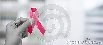 October Breast Cancer Awareness month, Woman holding Pink Ribbon for supporting people living and illness. Healthcare, Stock Photo