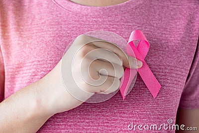 October Breast Cancer Awareness month, Woman in pink T- shirt with hand holding Pink Ribbon for supporting people living and Stock Photo