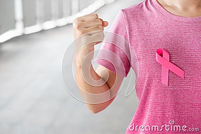 October Breast Cancer Awareness month, Woman in pink T- shirt with Pink Ribbon for supporting people living and illness. Stock Photo