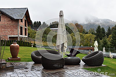 Rattan garden furniture, table and armchairs. Editorial Stock Photo