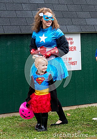 A mother and daughter dress in super women costumes during a Halloween event Editorial Stock Photo