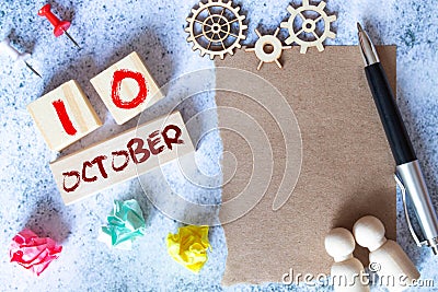 October 10 - Daily colorful Calendar with Block Notes and Pencil on wood table background. Stock Photo