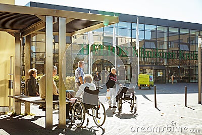 October 2018. Germany, Helios Klinikum Krefeld. A group of pensioners in wheel chairs rests on a square, in a park near the entran Editorial Stock Photo