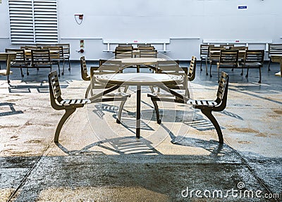 October 5, 2019 - Howe Sound, BC: Metal wheelchair accessible covered outdoor seats and tables on a BC Ferries ship. Editorial Stock Photo